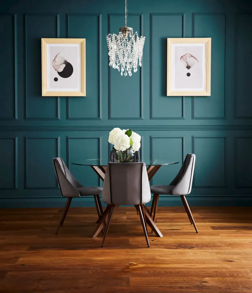 Dining room with deep teal panelling and oak flooring